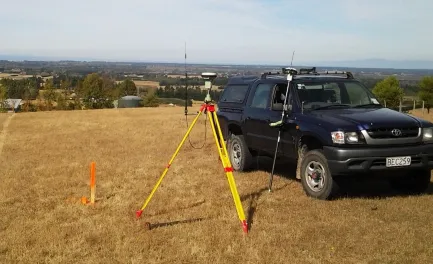 Tripod set up beside truck